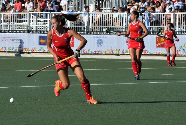 Chile's Camila Caram (L) takes control of the ball during the Women's Field Hockey semifinal match Argentina vs. Chile during the 2015 Pan American Games in Toronto on July 22, 2015. Argentina won 5-0. AFP PHOTO/EVA HAMBACH / AFP PHOTO / EVA HAMBACH